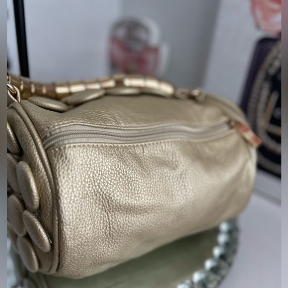 unique design with embossed circular details and a structured, metallic handle. - Picture 7 of 12